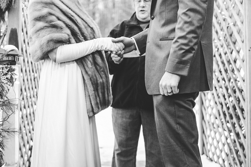 Bride and Groom holding hands during winter wedding ceremony Meredith NH